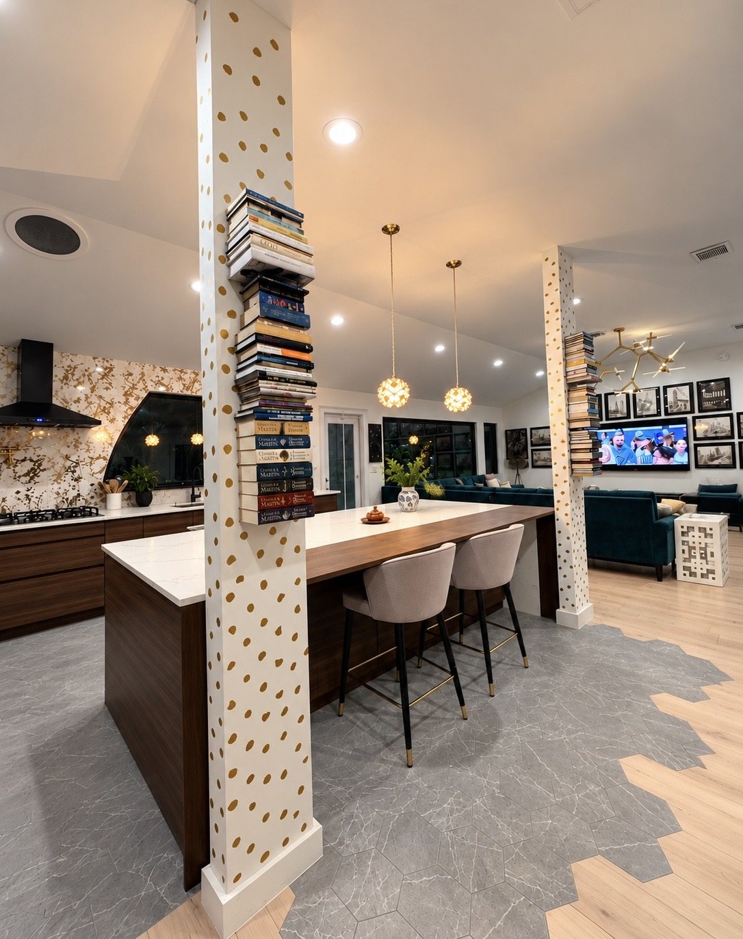 The finished kitchen and island framed by patterned columns